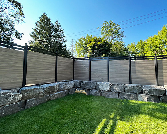 Grey vinyl fencing in backyard